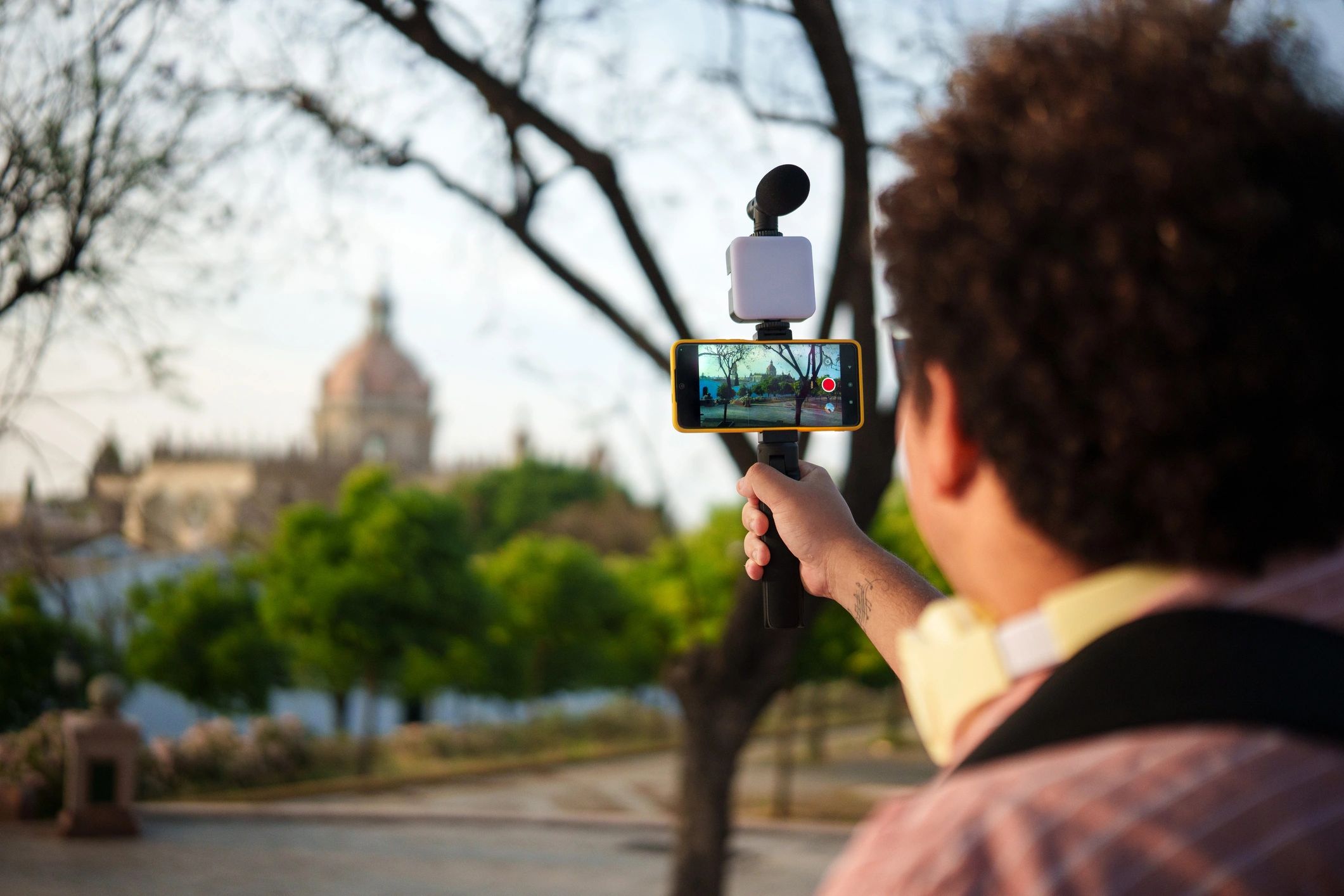 Content creator filming with a smartphone on a gimbal